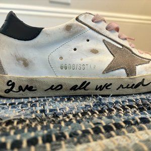 Super-Star sneakers with handwritten Love is all we need lettering